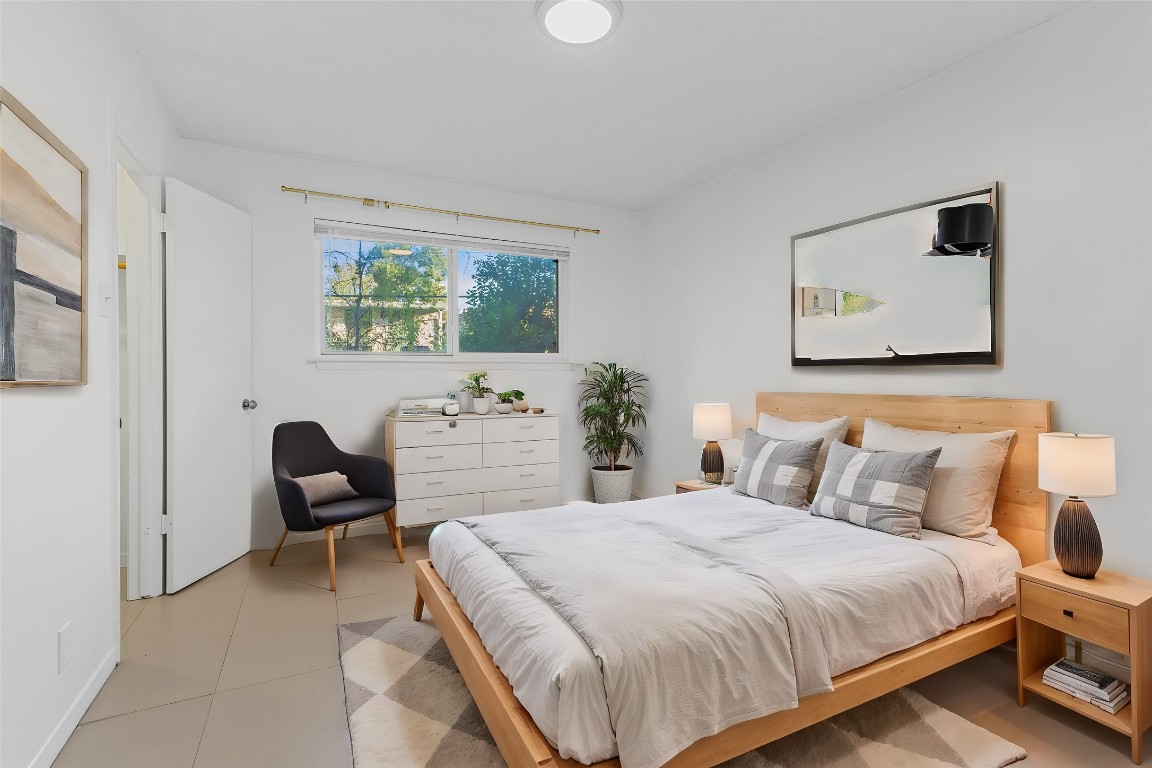 1907 Fairlawn Lane, Unit 3 Austin, TX 78704 - Photo 4 of 19 a bedroom with a bed and a chair