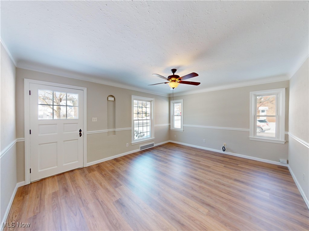 1343 Irene Road Lyndhurst, OH 44124 - Photo 2 of 32 Foyer entrance with crown molding, ceiling fan, and light wood-type flooring