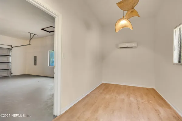 a view of a room with wooden floor and white walls