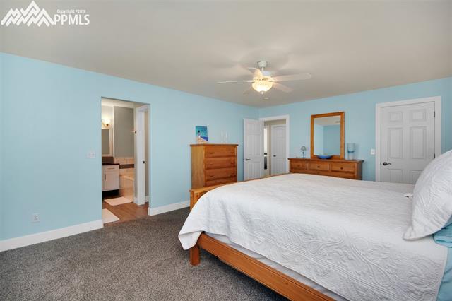 29850 Big Springs Road Calhan, CO 80808 - Photo 14 of 16 The natural colors of the new carpet(2017) is soft and a nice contrast to the soft blue and white walls, ceiling, trim and doors. This is a peak into the master bathroom, hallway and doorway into the walk in closet. This 221 s/f room is spacious, immaculate and offers a refuge from the stress of a busy day.