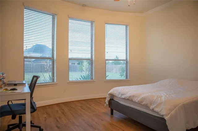 a bed sitting in a bedroom next to a window