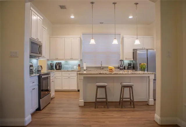a kitchen with a sink cabinets and window