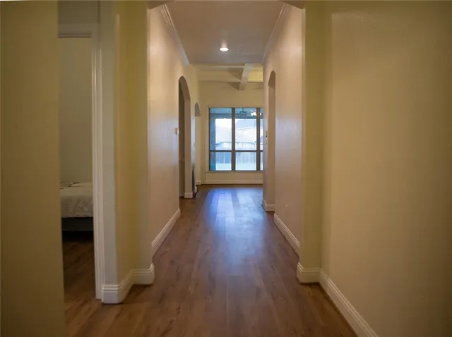 a view of a hallway with wooden floor