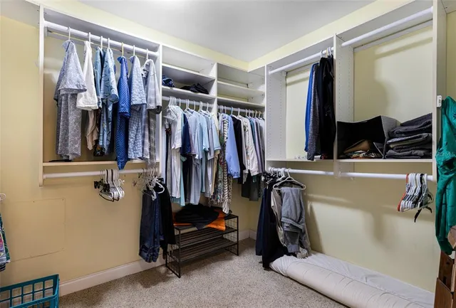 a spacious bedroom with a bed and a chandelier