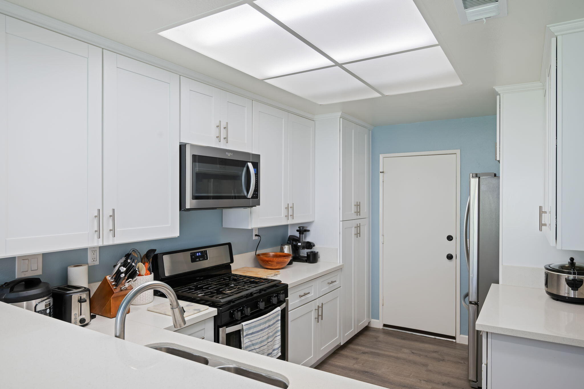 222 Ute Lane Ventura, CA 93001 - Photo 8 of 29 a kitchen with stainless steel appliances a stove a sink and a refrigerator