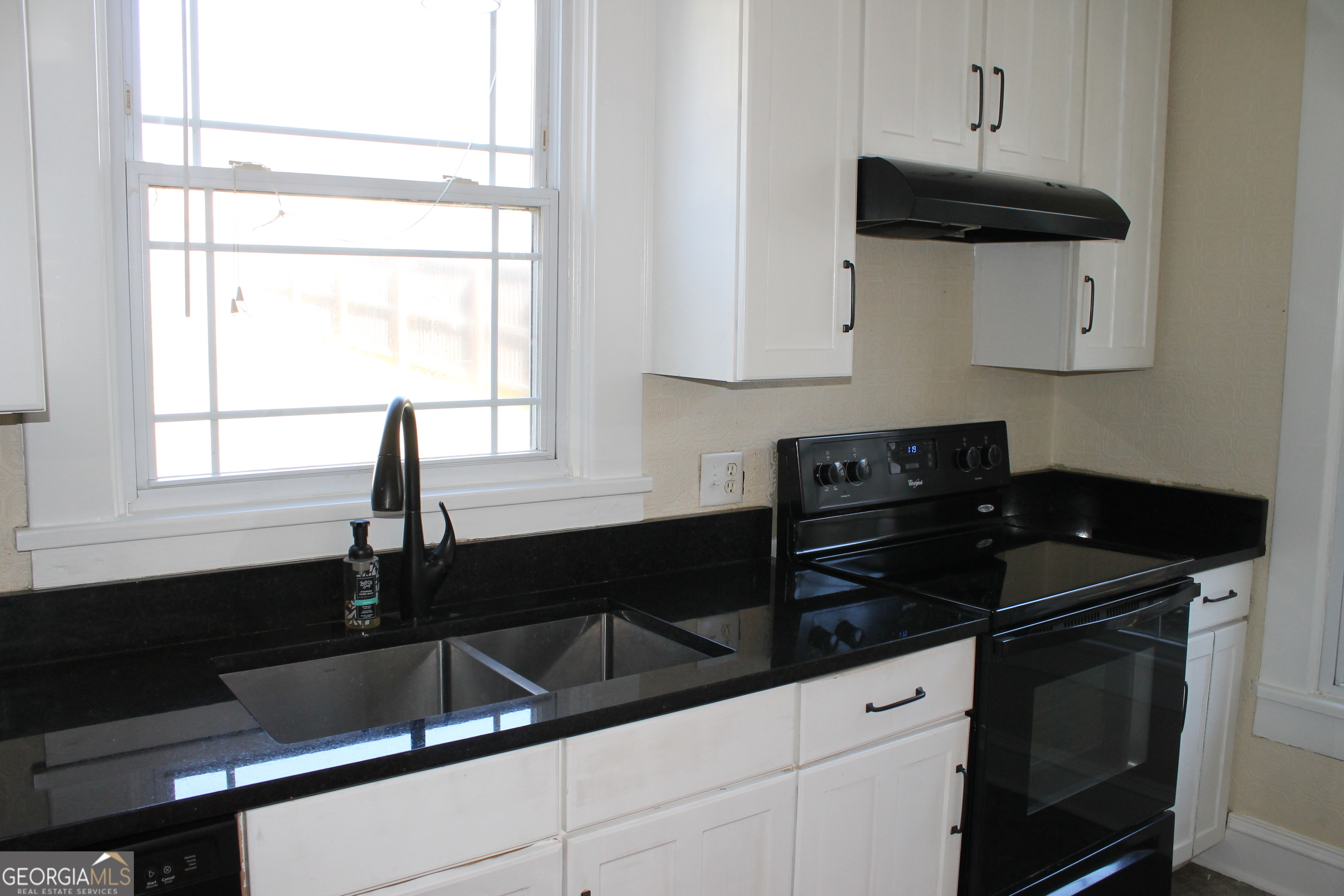 71 Clark Street Newnan, GA 30263 - Photo 5 of 19 a kitchen with a sink and cabinets
