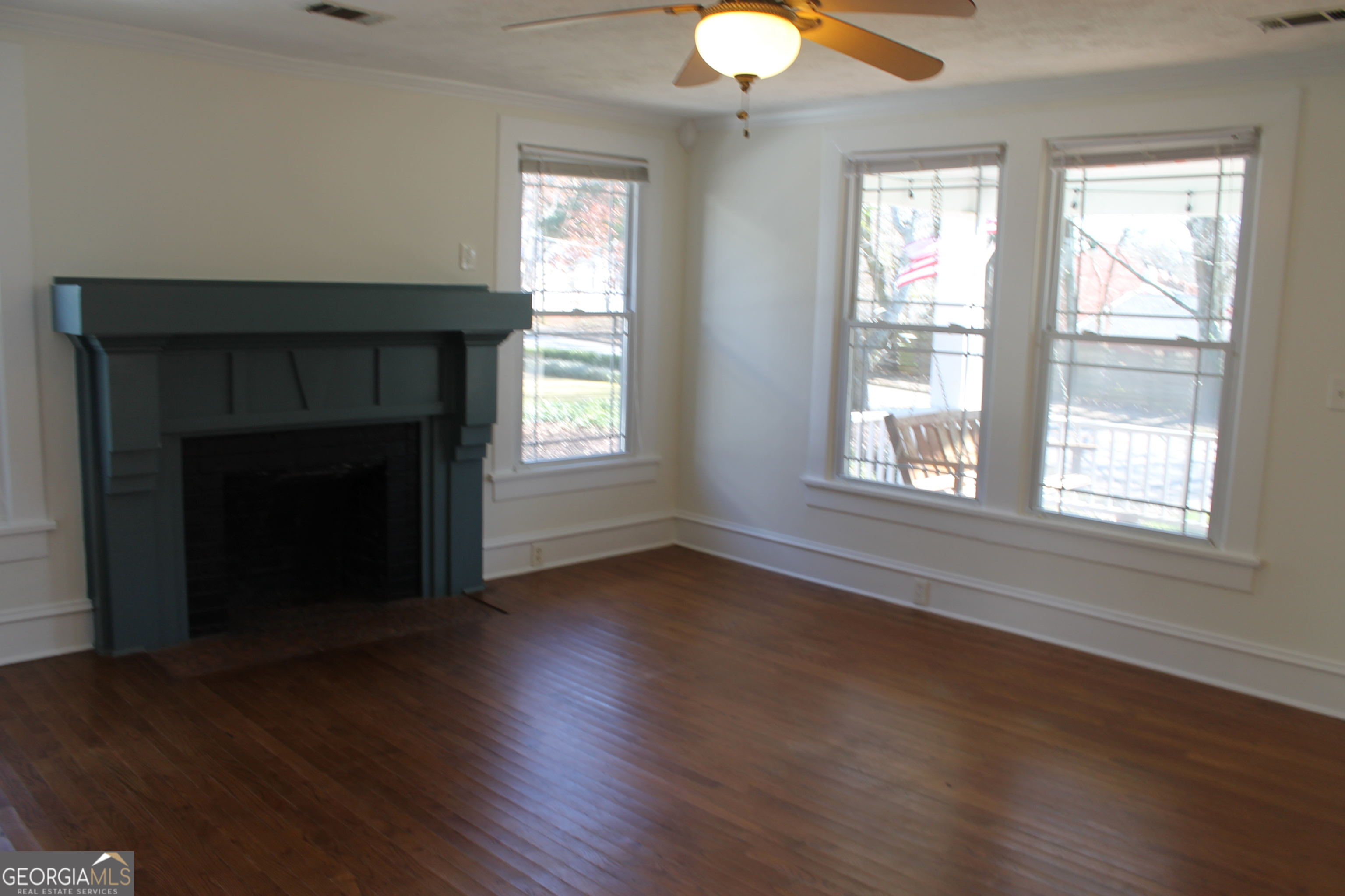 71 Clark Street Newnan, GA 30263 - Photo 7 of 19 a view of an empty room with wooden floor and a window