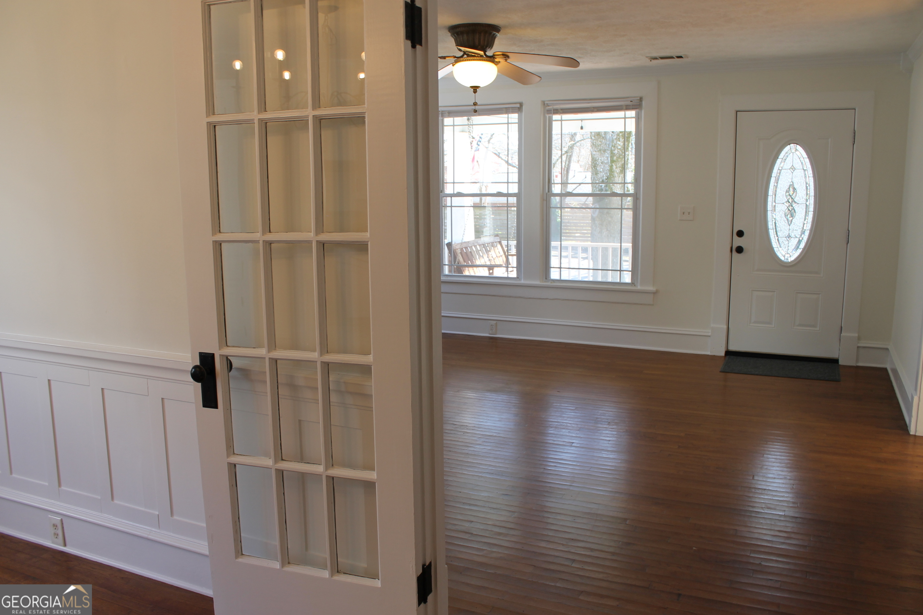 71 Clark Street Newnan, GA 30263 - Photo 9 of 19 an empty room with wooden floor cabinet and windows