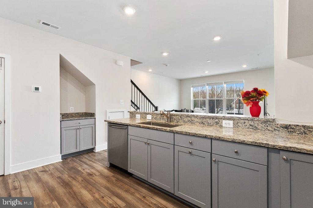 7203 Gringotts Way, Unit A Elkridge, MD 21075 - Photo 5 of 23 a kitchen with granite countertop a sink and cabinets