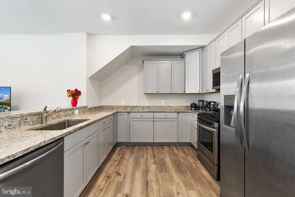 7203 Gringotts Way, Unit A Elkridge, MD 21075 - Photo 6 of 23 a kitchen with a sink stove and refrigerator