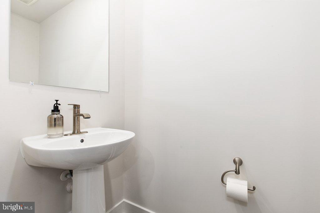 7203 Gringotts Way, Unit A Elkridge, MD 21075 - Photo 8 of 23 a bathroom with a sink and a mirror