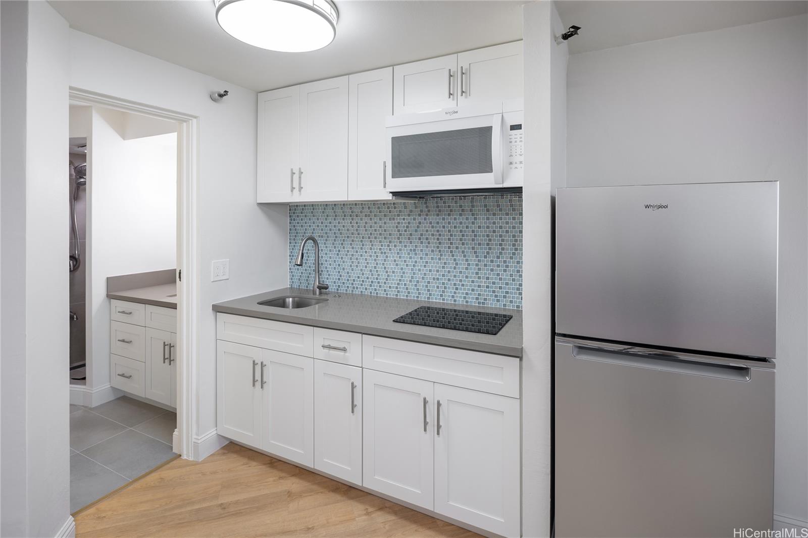 1700 Ala Moana Boulevard, Unit 3104 Honolulu, HI 96815 - Photo 4 of 15 a kitchen with a sink and white cabinets