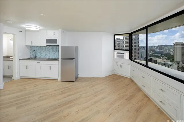 a large white kitchen with a large window