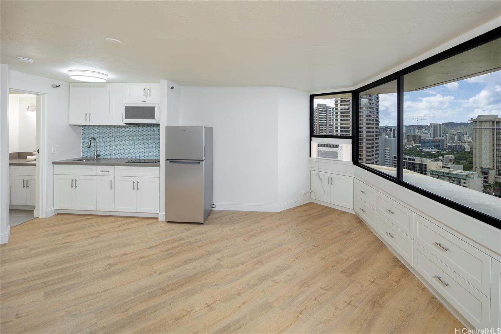 1700 Ala Moana Boulevard, Unit 3104 Honolulu, HI 96815 - Photo 6 of 15 a large white kitchen with a large window