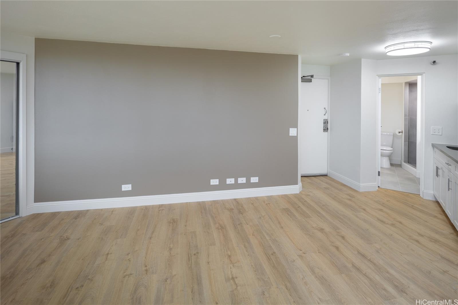 1700 Ala Moana Boulevard, Unit 3104 Honolulu, HI 96815 - Photo 7 of 15 a view of an empty room and wooden floor