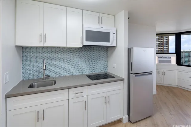 a kitchen with stainless steel appliances white cabinets and a sink