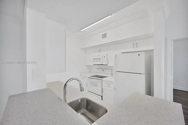 a kitchen with a refrigerator and cabinets