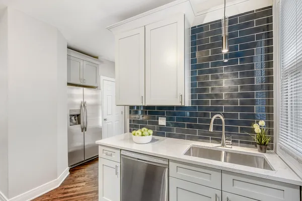 a kitchen with a sink and a refrigerator