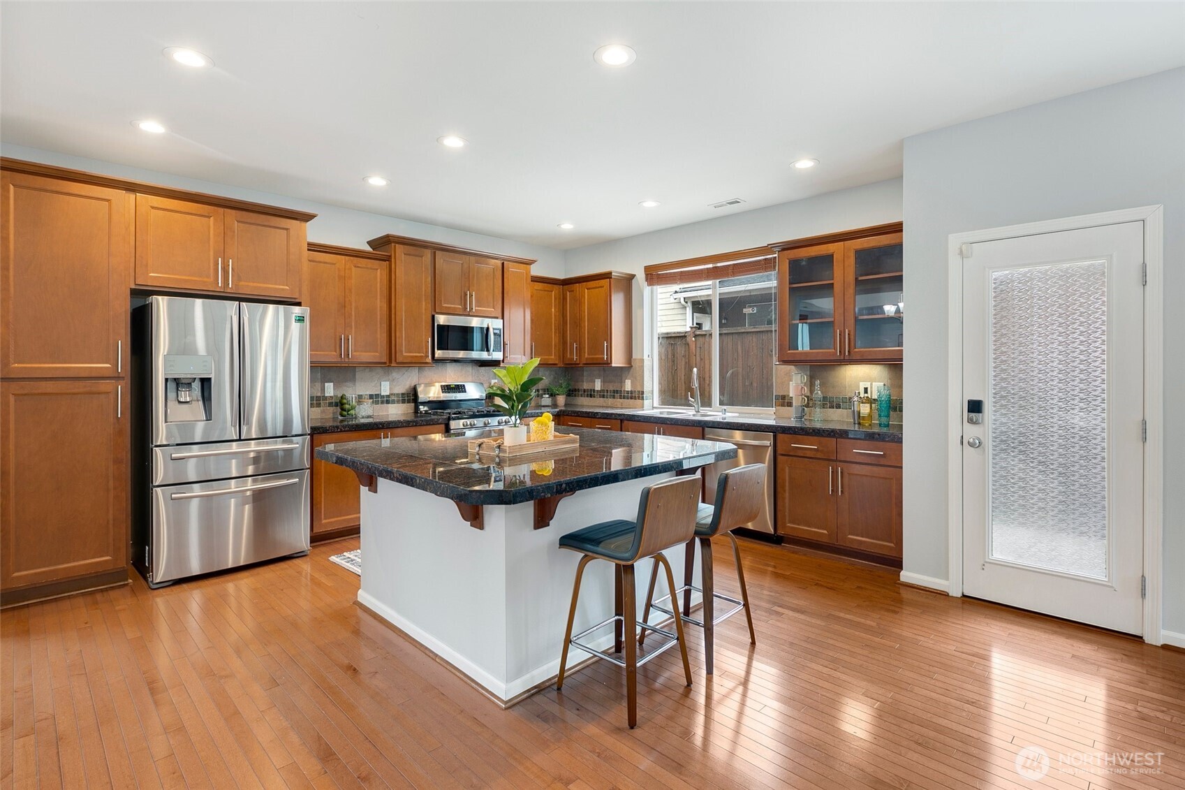 3931 177th Street Southeast Bothell, WA 98012 - Photo 10 of 39 a kitchen with stainless steel appliances granite countertop a refrigerator and a stove top oven