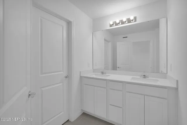 a bathroom with a double vanity sink and mirror