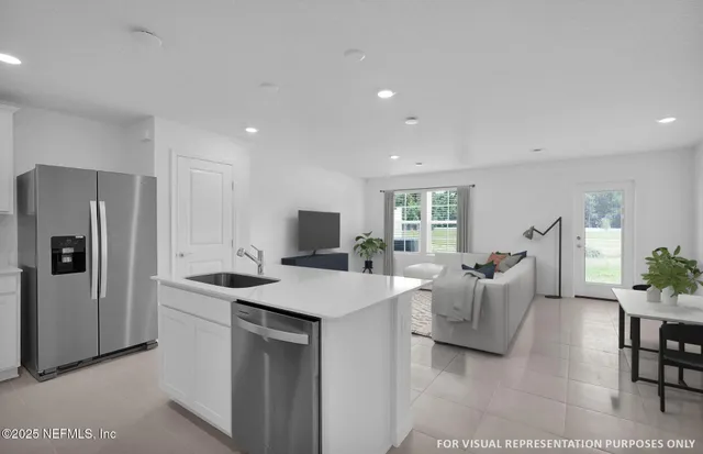 a kitchen with stainless steel appliances granite countertop a sink a refrigerator and a stove