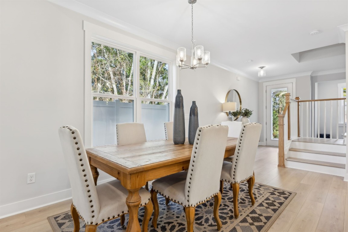 649 South 7th Street Fernandina Beach, FL 32034 - Photo 12 of 35 a view of a dining room with furniture a chandelier and wooden floor