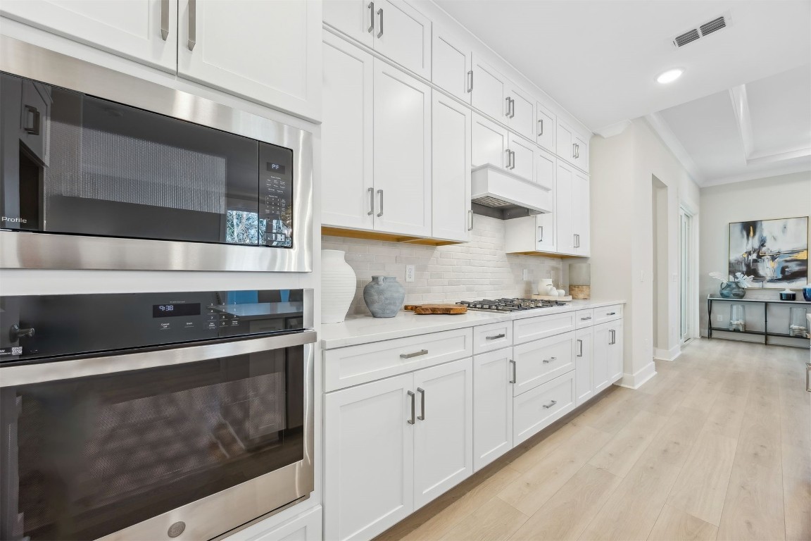 649 South 7th Street Fernandina Beach, FL 32034 - Photo 14 of 35 a kitchen with stainless steel appliances granite countertop white cabinets and window