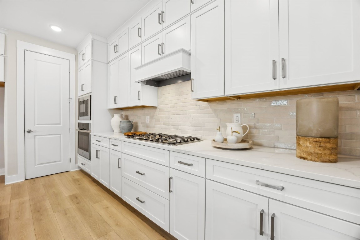 649 South 7th Street Fernandina Beach, FL 32034 - Photo 15 of 35 a kitchen with granite countertop white cabinets and white appliances
