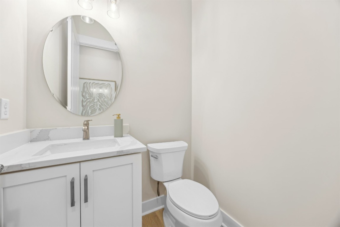 649 South 7th Street Fernandina Beach, FL 32034 - Photo 16 of 35 a bathroom with a toilet a sink and mirror