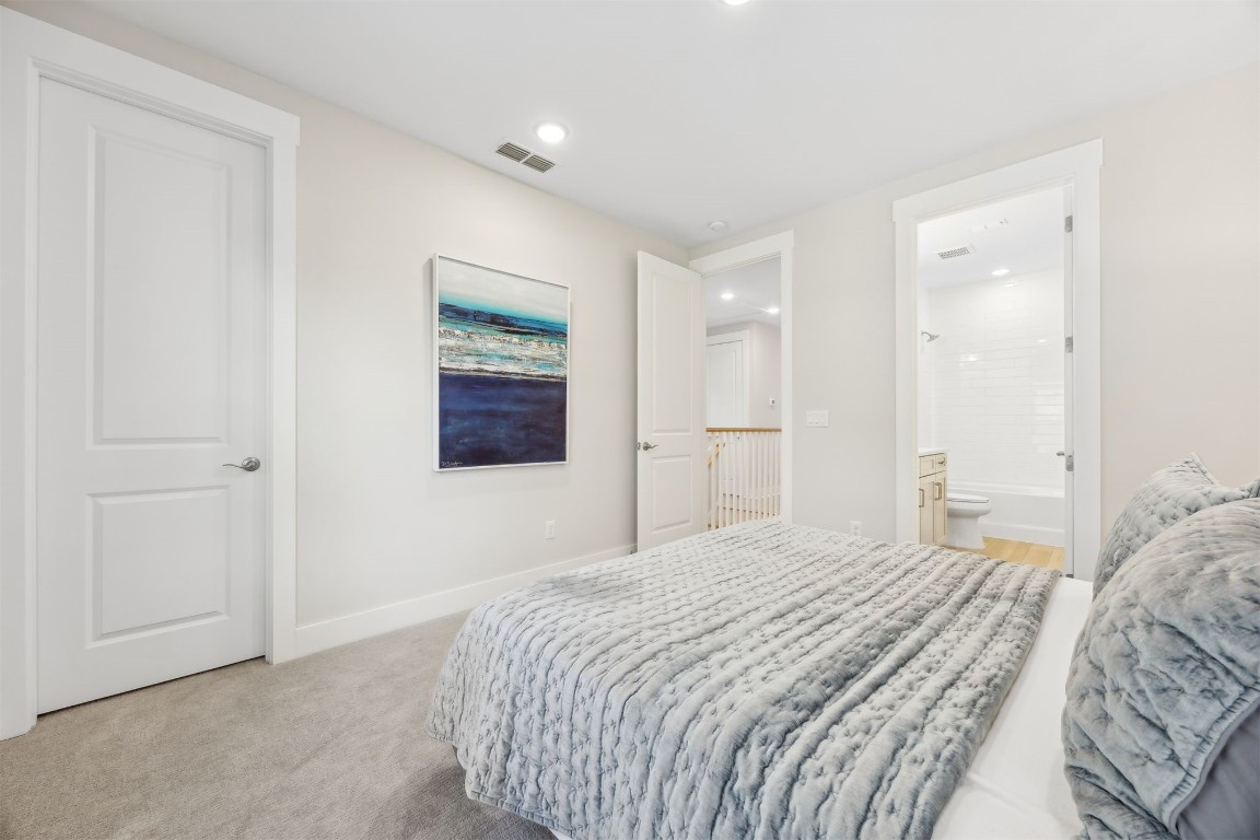 649 South 7th Street Fernandina Beach, FL 32034 - Photo 23 of 35 a bedroom with a bed and a painting