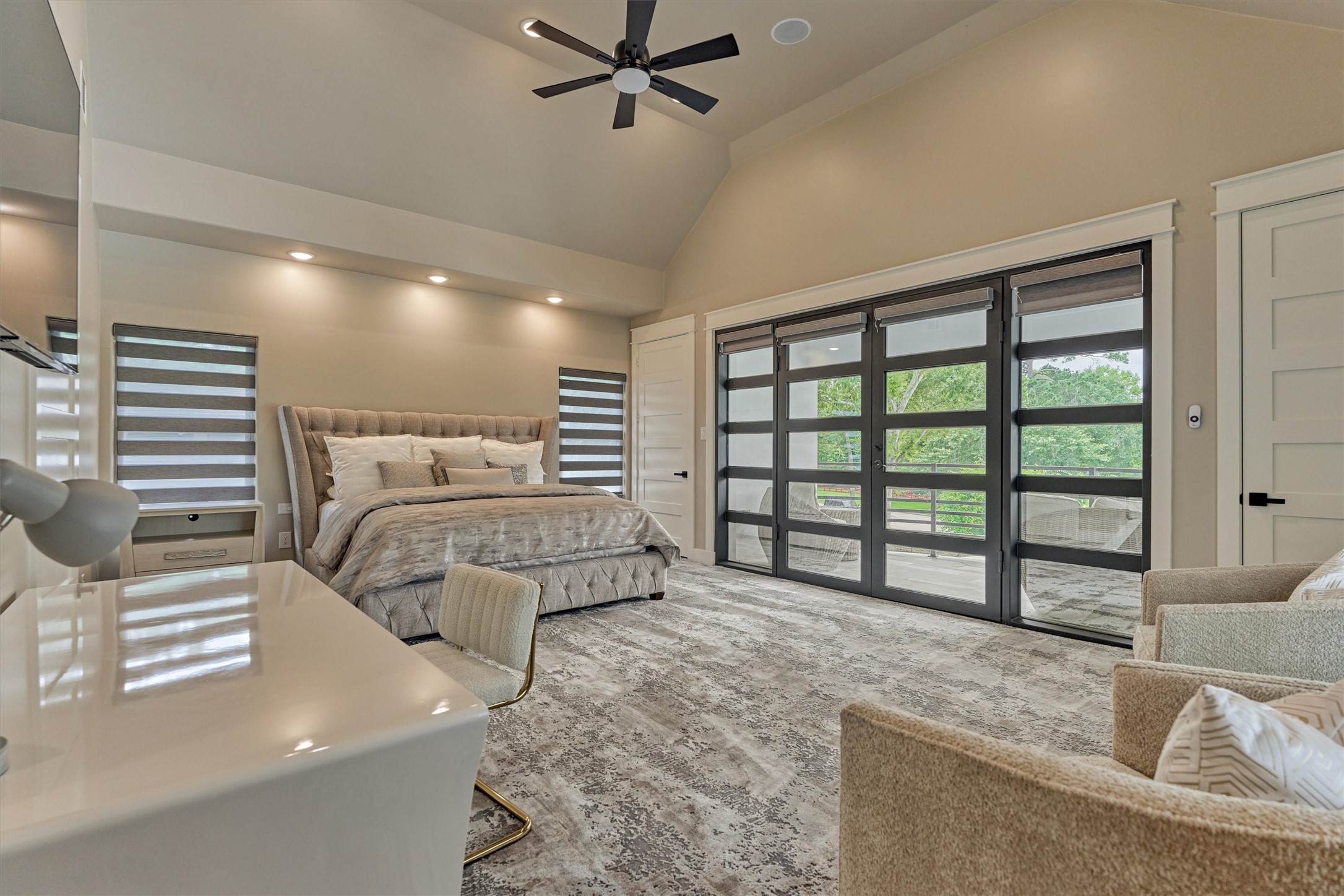 1907 Woerner Road Houston, TX 77090 - Photo 38 of 50 Second floor primary bedroom! Double steel doors with remote operated shades, lead to private balcony overlooking the lush front lawn.