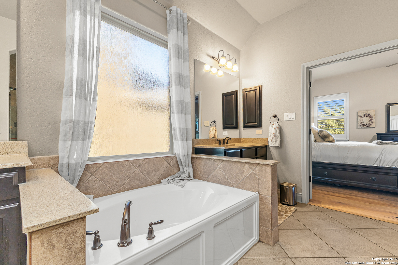 28938 Fairs Gate Fair Oaks Ranch, TX 78015 - Photo 31 of 41 a bathroom with a tub sink and mirror