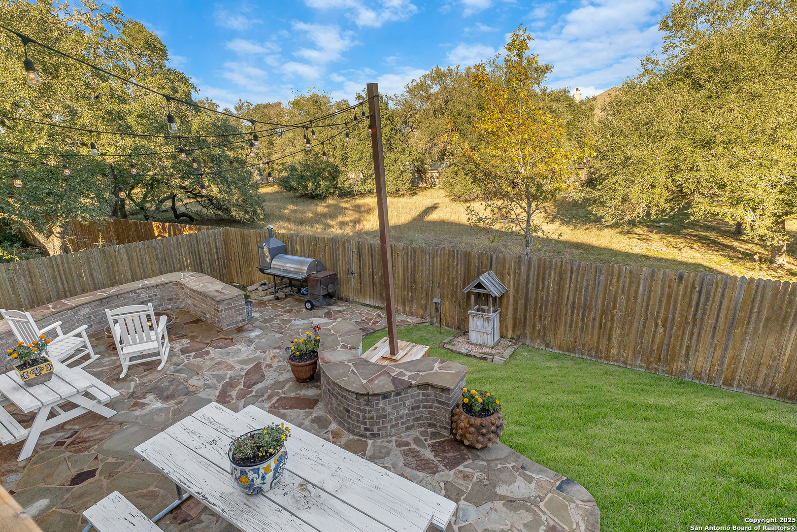 28938 Fairs Gate Fair Oaks Ranch, TX 78015 - Photo 40 of 41 a view of a backyard with table and chairs potted plants and wooden fence