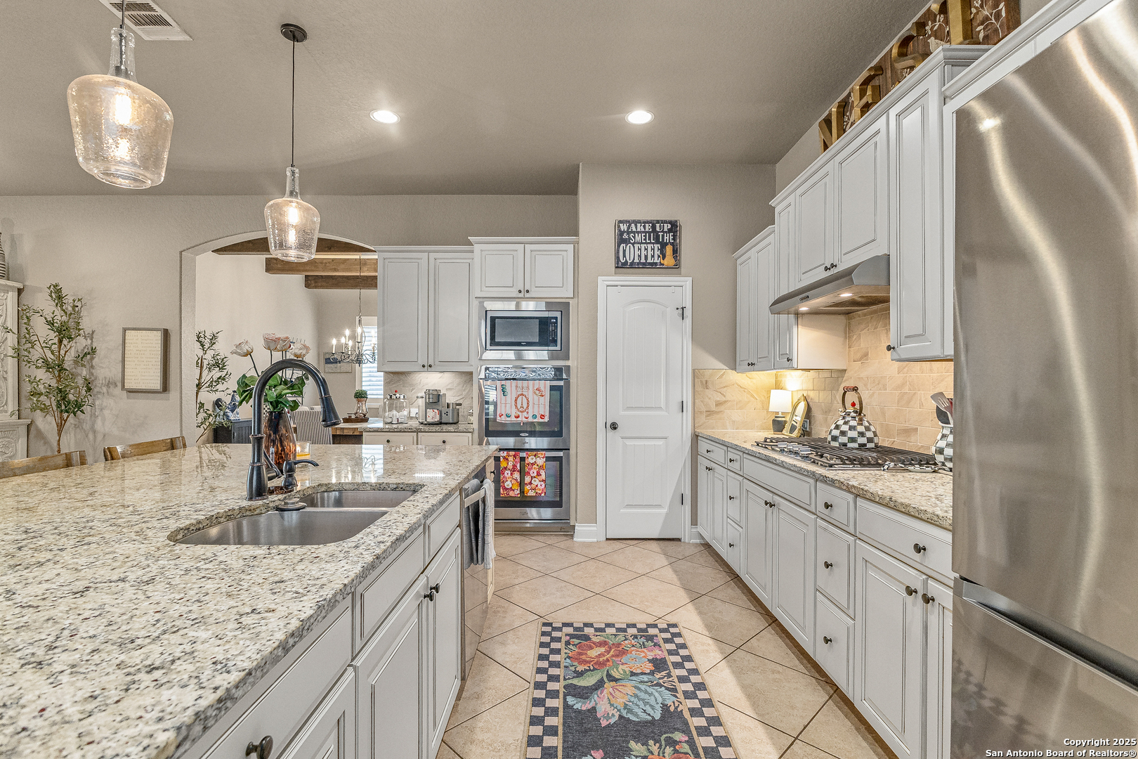 28938 Fairs Gate Fair Oaks Ranch, TX 78015 - Photo 7 of 41 a kitchen with stainless steel appliances granite countertop a sink a stove and a wooden floors