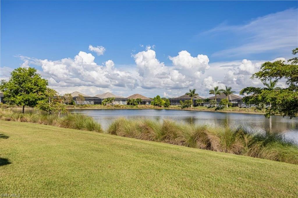6152 Rodney Bay Lane Naples, FL 34113 - Photo 14 of 45 a view of a lake in a city