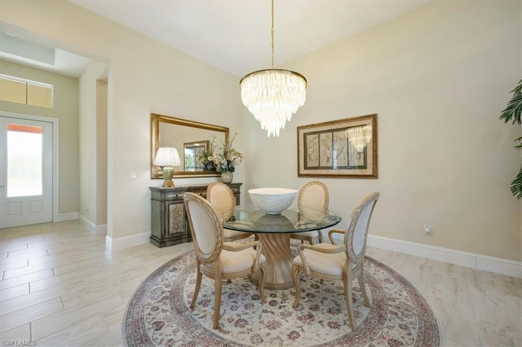 6152 Rodney Bay Lane Naples, FL 34113 - Photo 15 of 45 a dining room with furniture and window