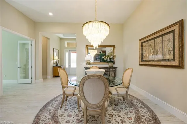 a living room with furniture a window and a chandelier