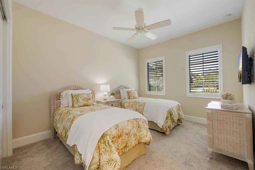 6152 Rodney Bay Lane Naples, FL 34113 - Photo 21 of 45 a bedroom with two beds and a window
