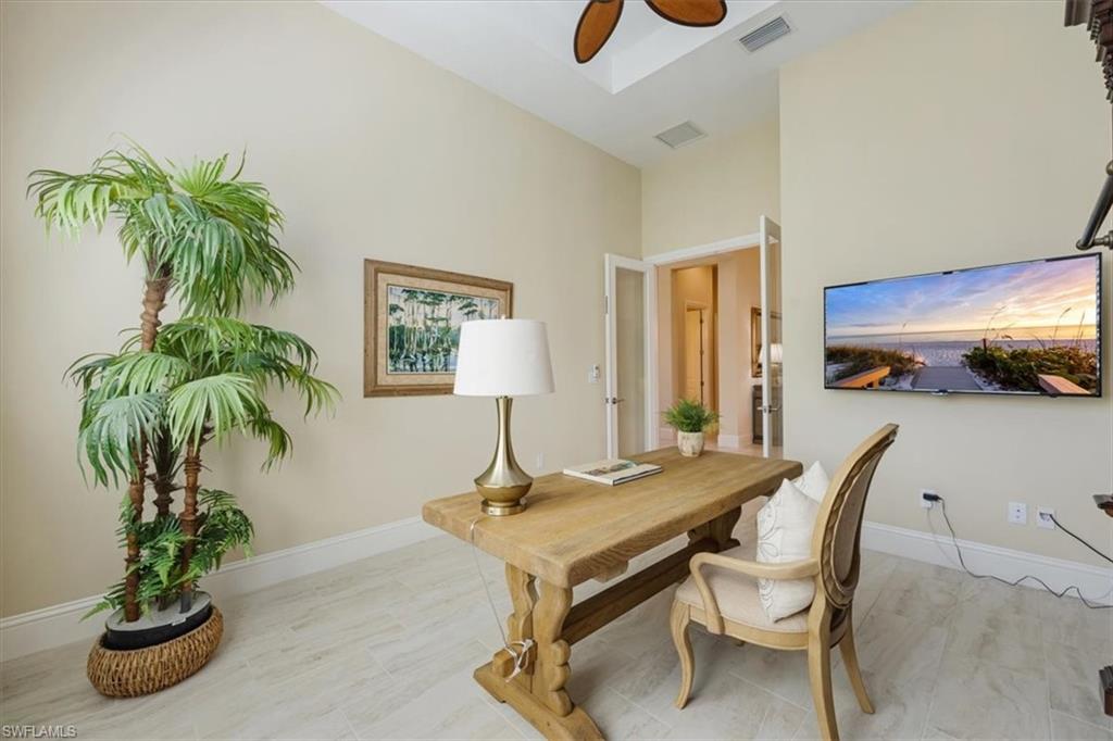 6152 Rodney Bay Lane Naples, FL 34113 - Photo 25 of 45 a living room with furniture and potted plant