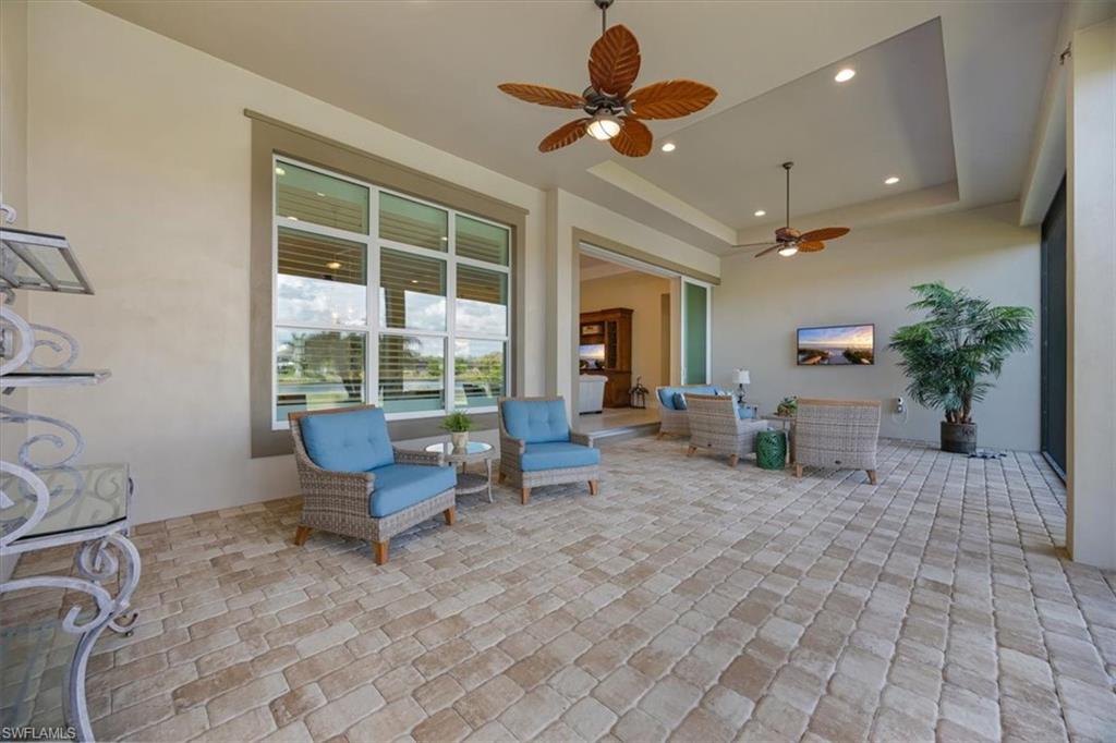 6152 Rodney Bay Lane Naples, FL 34113 - Photo 28 of 45 a living room with furniture and a large window