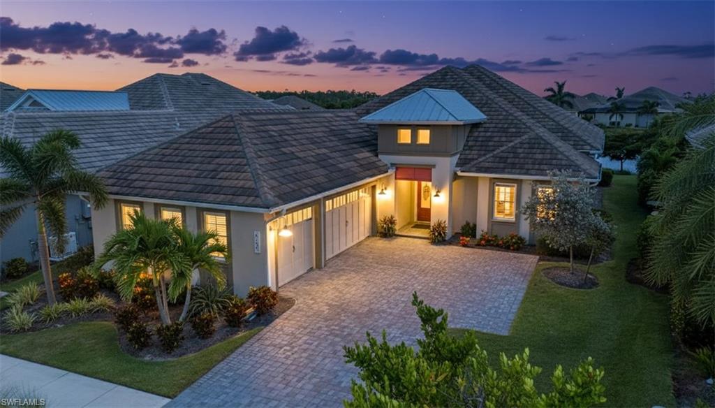 6152 Rodney Bay Lane Naples, FL 34113 - Photo 31 of 45 a front view of house with a garden