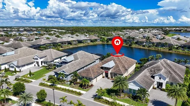 an aerial view of a house with a swimming pool and a yard