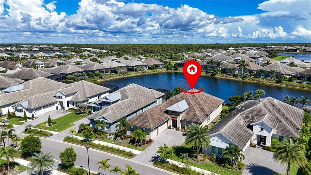 6152 Rodney Bay Lane Naples, FL 34113 - Photo 32 of 45 an aerial view of a house with a swimming pool and a yard