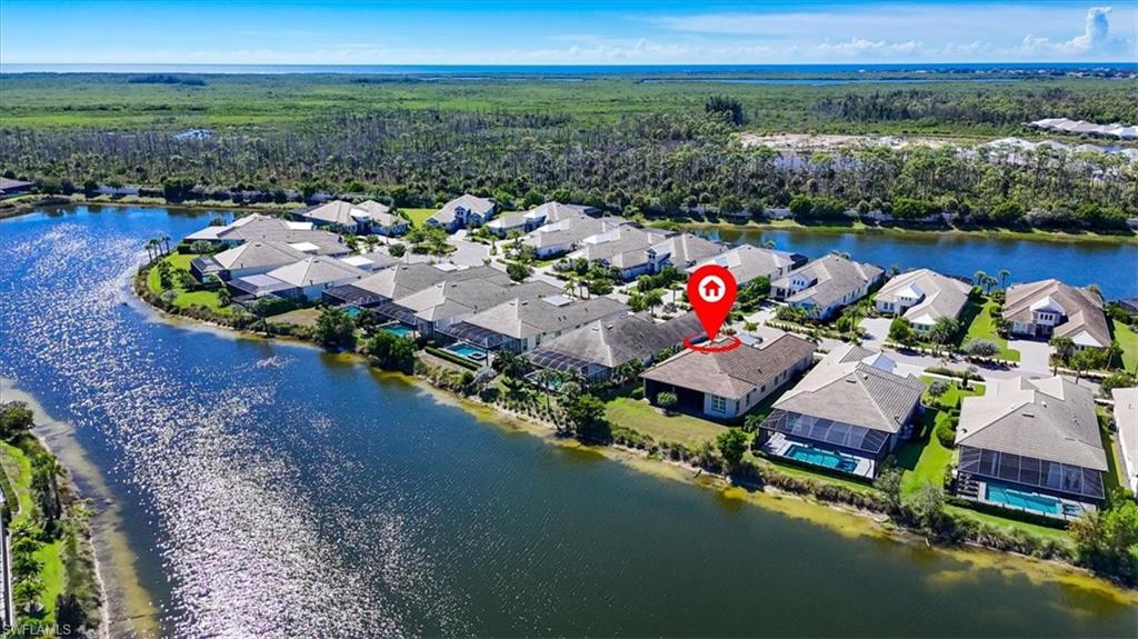 6152 Rodney Bay Lane Naples, FL 34113 - Photo 35 of 45 an aerial view of a house with a garden and lake view