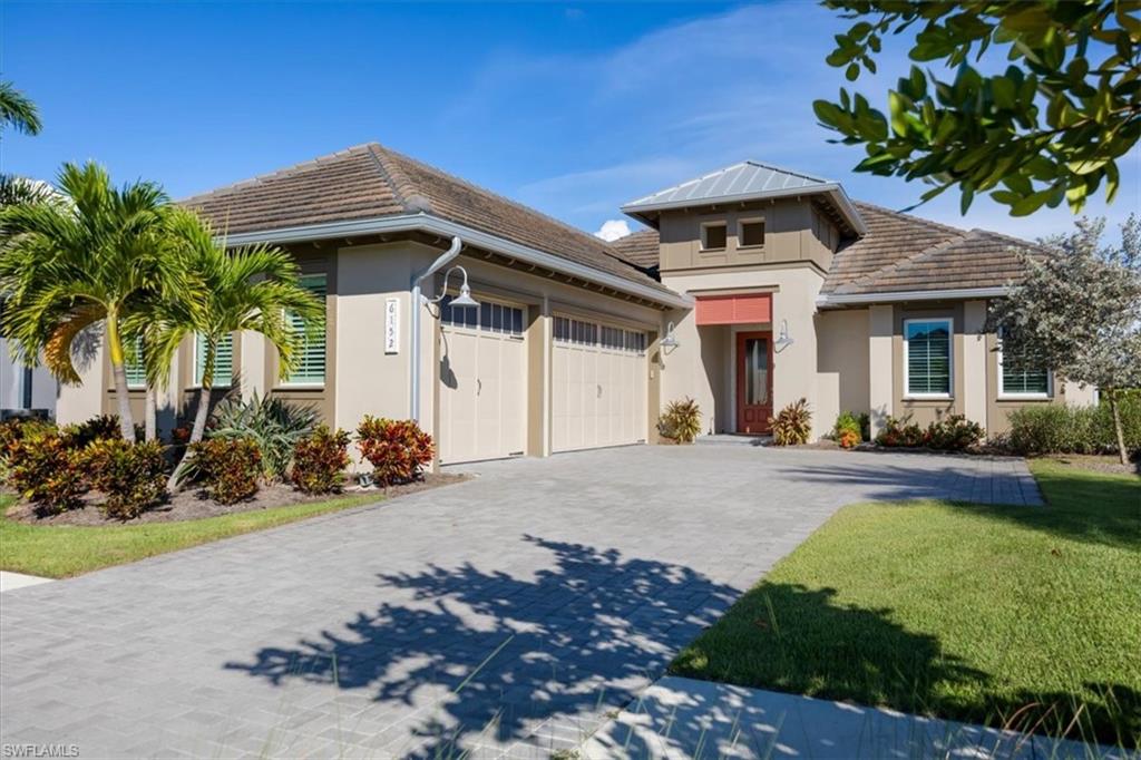 6152 Rodney Bay Lane Naples, FL 34113 - Photo 37 of 45 a front view of a house with garden