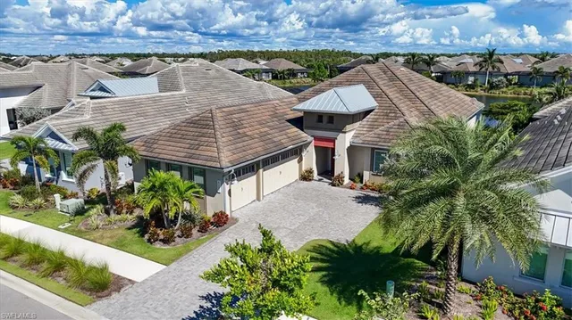 an aerial view of a house with a yard and potted plants