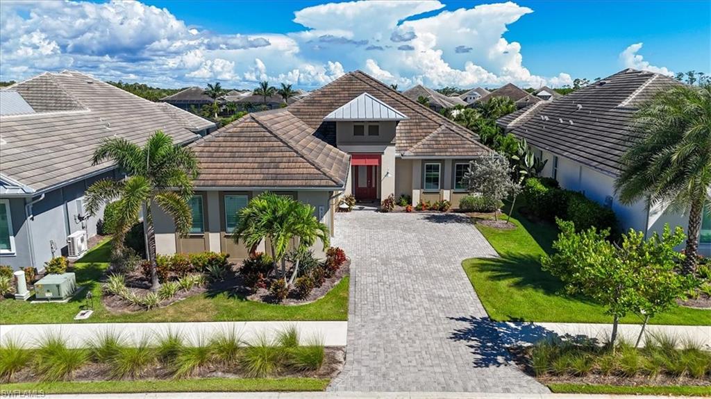 6152 Rodney Bay Lane Naples, FL 34113 - Photo 39 of 45 a front view of a house with garden