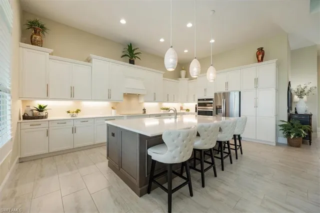 a kitchen with a sink dining table and chairs