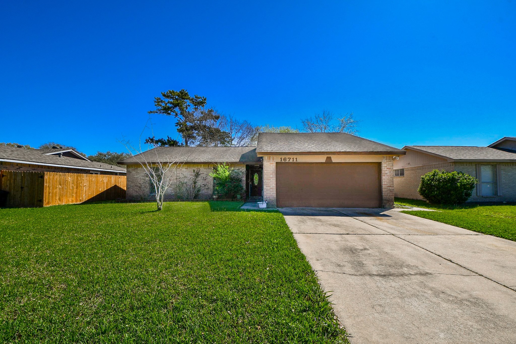 16711 Ribbonridge Drive Sugar Land, TX 77498 - Photo 4 of 24 a front view of a house with a yard and garage