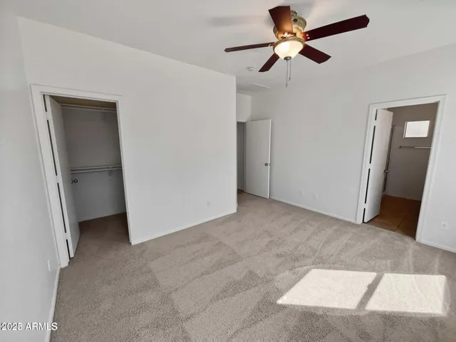 a view of empty room with ceiling fan
